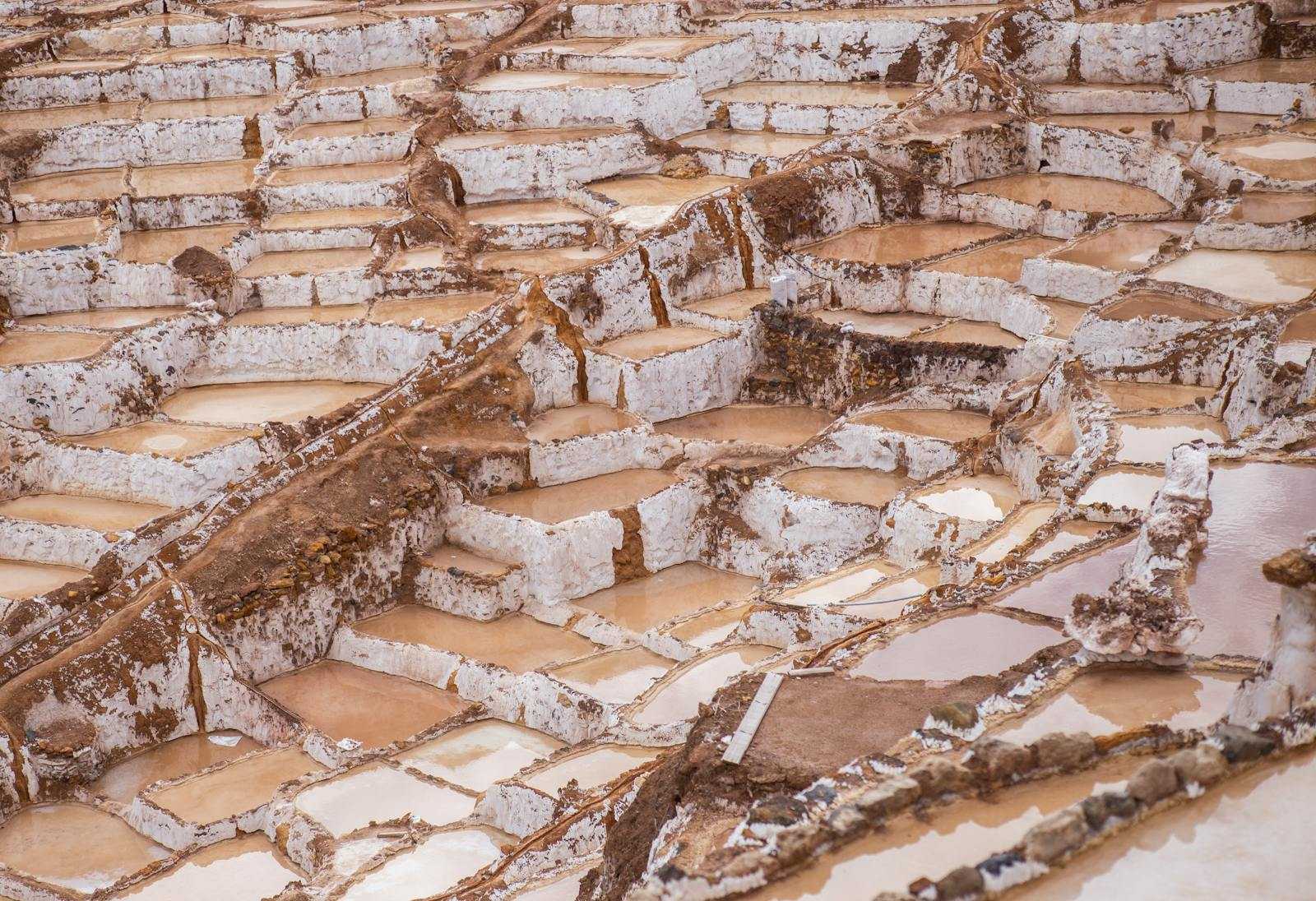 Aerial image of salt pans in use for traditional salt harvesting.